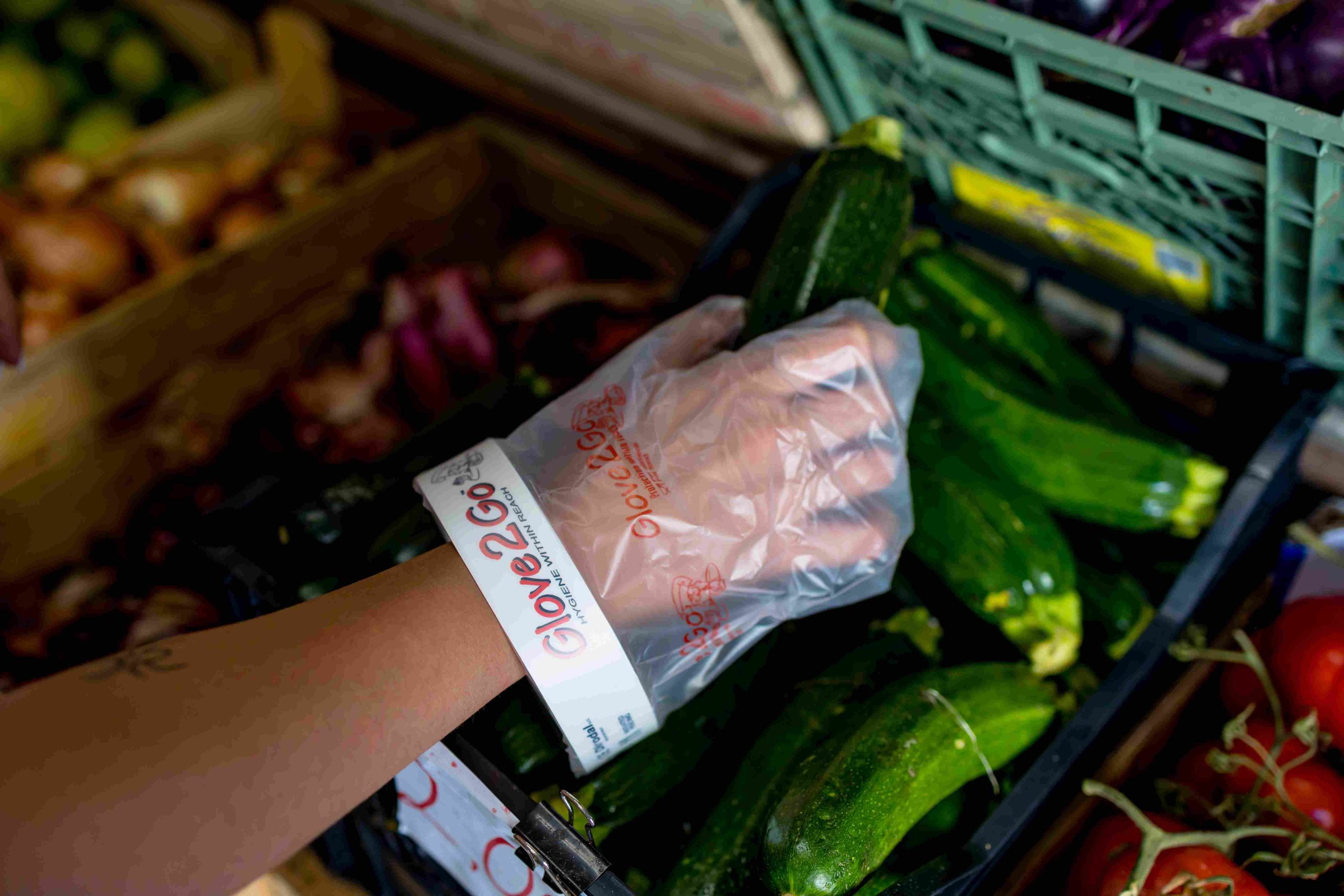 Glove2Go glove being used while handling fresh produce in a food retail setting.