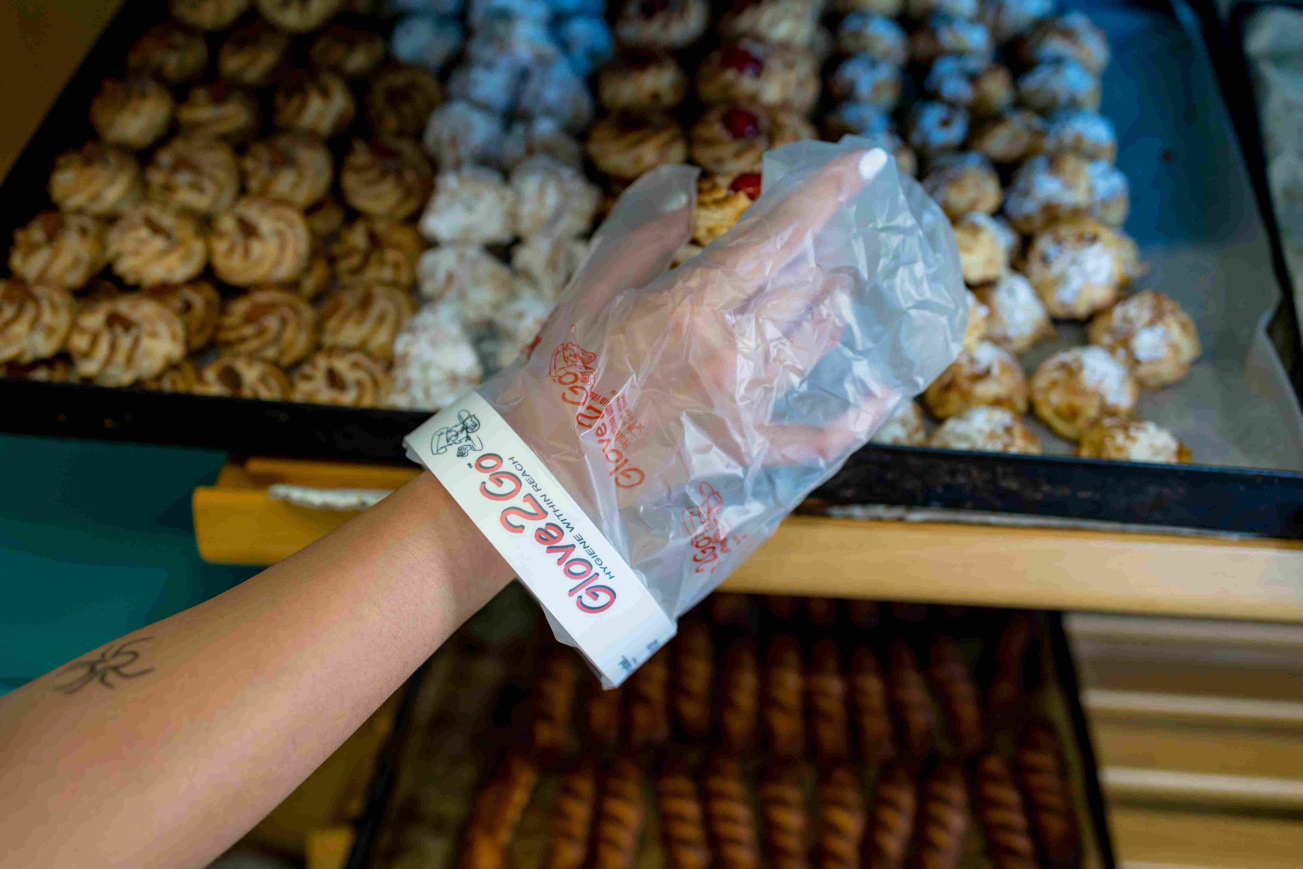 Glove2Go glove used near a tray of small pastries.